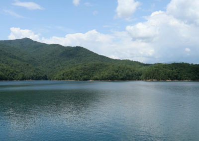 Serene lake surrounded by lush green mountains