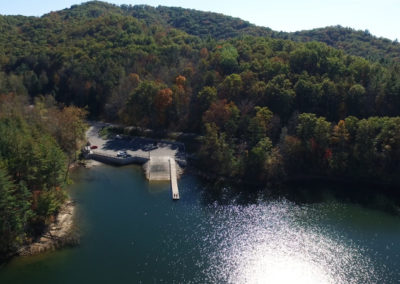 Aerial view of a tranquil lake surrounded by colorful autumn foliage