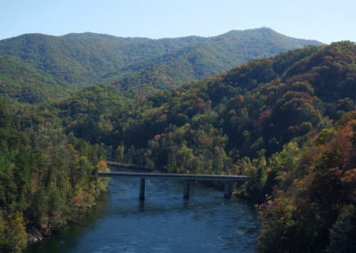 A scenic view of a river flowing under a bridge