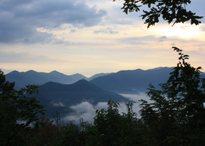 Sunlit mountain range at dawn, with layered peaks