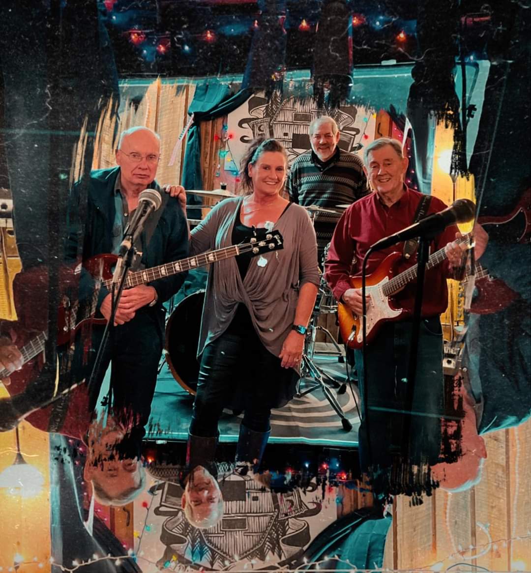 A group of five musicians stands together on stage, holding instruments