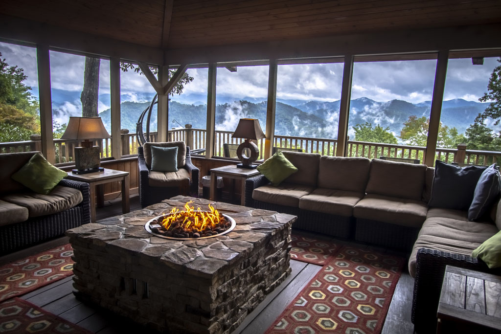 Lovely sunroom/covered deck with plentiful seating and view of the Blue Ridge Mountains.