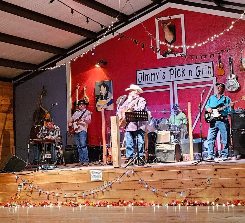 A live country band performs on stage at Jimmy's Pick n Grin