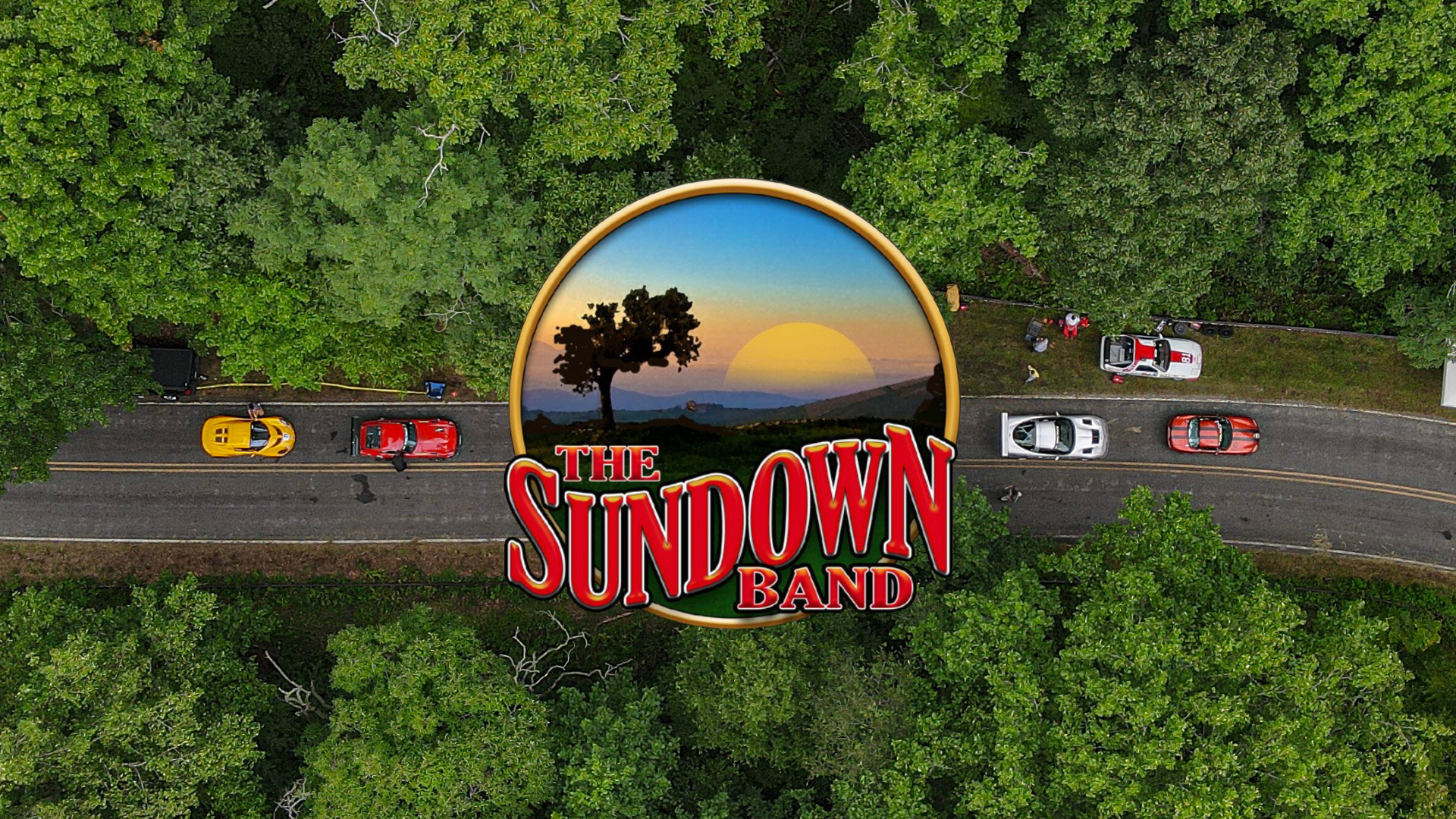 Event image featuring the logo for the Sundown Band overlaid on an aerial view of a road with race cars on a slightly winding road