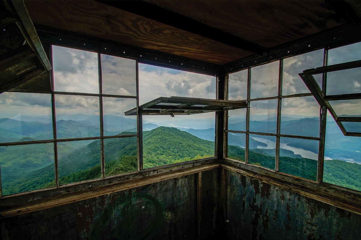 Lovely sunroom/covered deck with plentiful seating and view of the Blue Ridge Mountains.